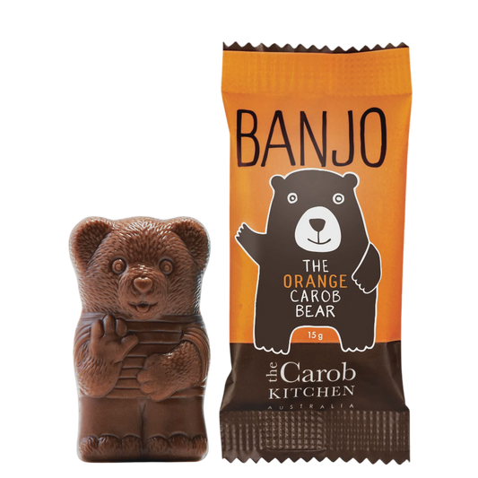 Chocolate bear with orange carob bear packaging featuring 'Banjo' and 'The Carob Kitchen' branding.